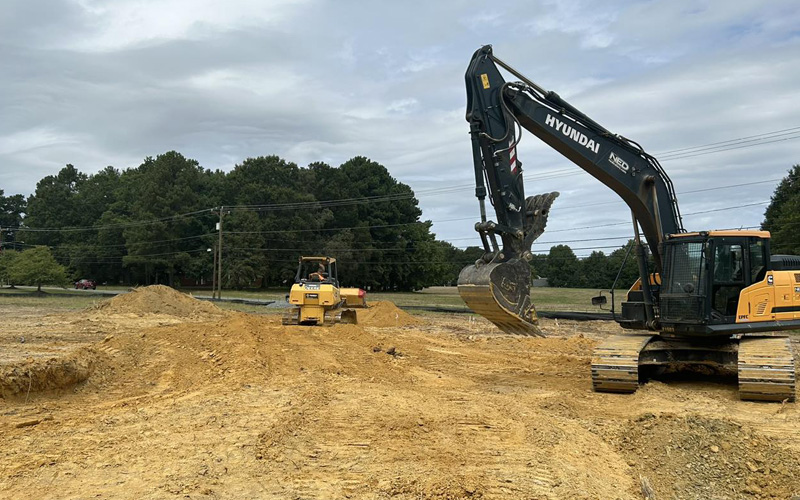 Excavator and bulldozer working on a construction site with earth moving equipment.